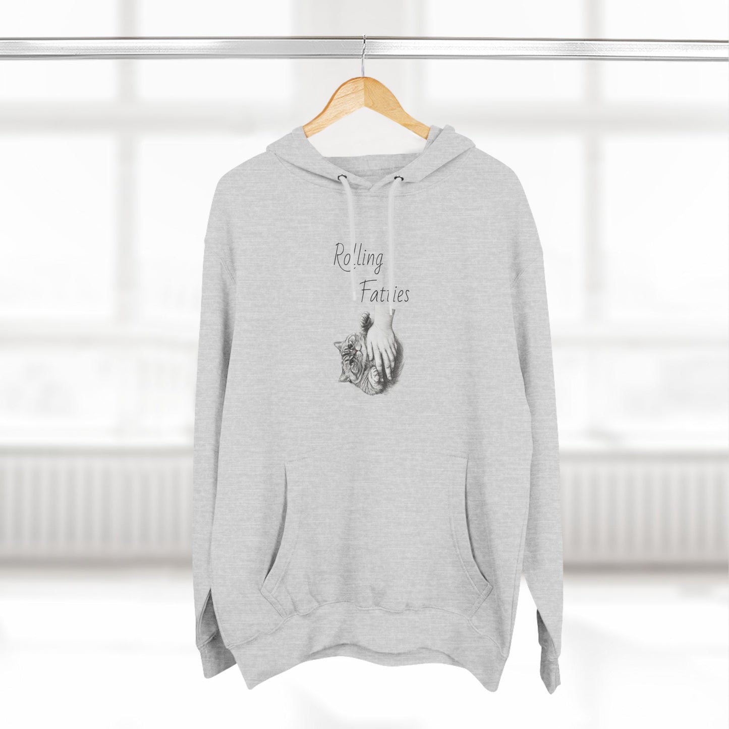 Heather gray Rolling Fatties Hoodie hanging on a wooden hanger in a bright setting. A versatile and stylish wardrobe essential.